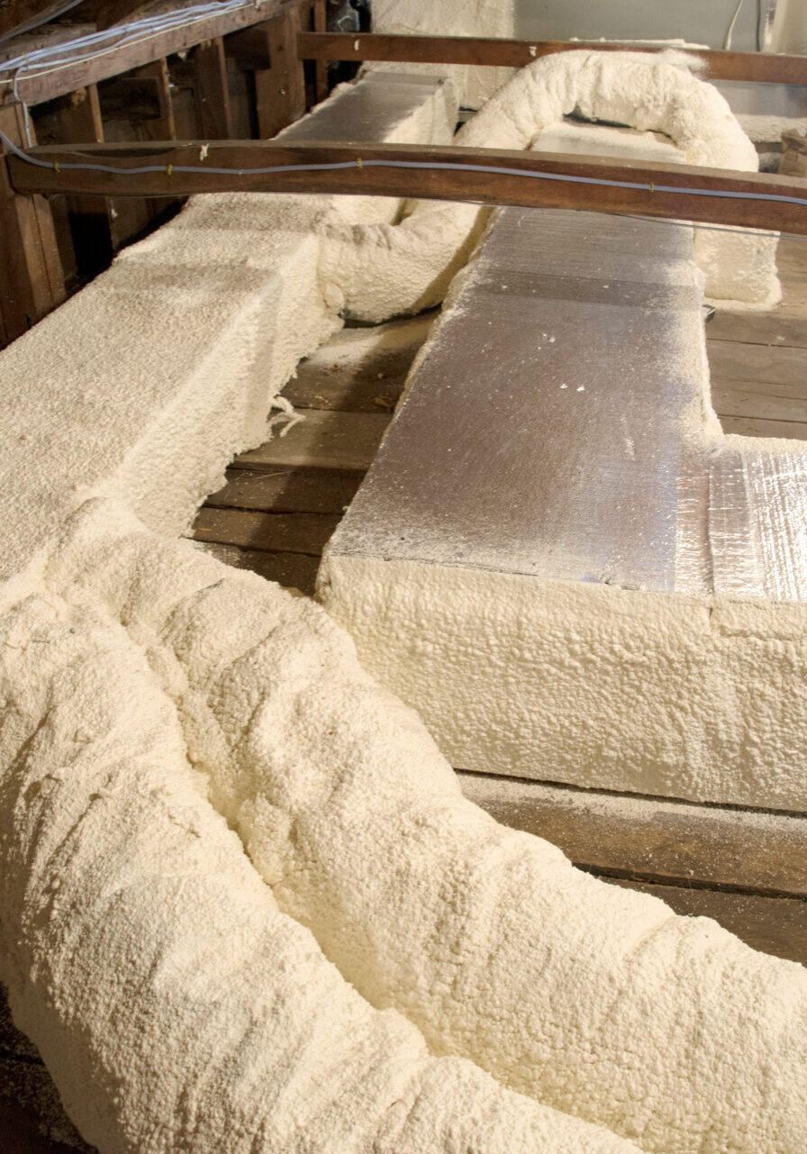 Duct encapsulation in attic system with spray foam to reduce condensation. Installed by Dr. Energy Saver
