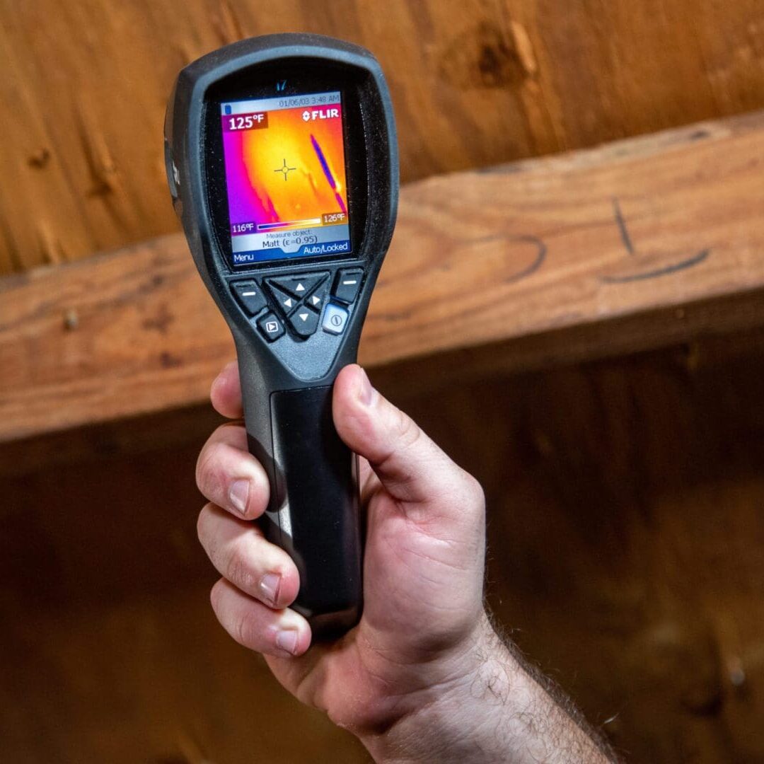 Thermal camera scanning an attic during a professional home energy evaluation.